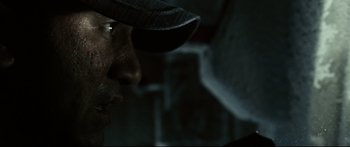 Movie still from “Sunshine” (2007), directed by Danny Boyle – A person wearing a hat; Extreme Close Up shot, Low angle