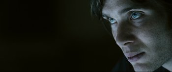 Movie still from “Sunshine” (2007), directed by Danny Boyle – A person's face in the dark; Extreme Close Up shot, Over the shoulder angle