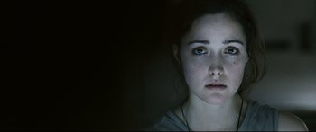 Movie still from “Sunshine” (2007), directed by Danny Boyle – A young woman is looking into the camera; Close Up shot, Over the shoulder angle