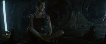 Movie still from “Sunshine” (2007), directed by Danny Boyle – A woman sitting on the ground in front of a fan; Medium shot, High angle