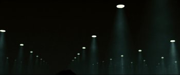 Movie still from “Sunshine” (2007), directed by Danny Boyle – A row of street lights lit up at night; Extreme Wide shot, Low angle