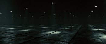Movie still from “Sunshine” (2007), directed by Danny Boyle – A person is standing in a dark room; Extreme Wide shot, High angle