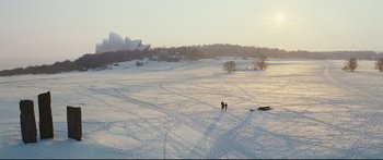 Movie still from “Sunshine” (2007), directed by Danny Boyle – Two people are walking in the snow on a field; Extreme Wide shot, High angle