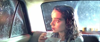 Movie still from “Suspiria” (1977), directed by Dario Argento – A woman sitting in the back of a car with her eyes closed; Close Up shot, Low angle