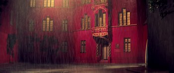 Movie still from “Suspiria” (1977), directed by Dario Argento – A red building with a yellow and red trim; Extreme Wide shot, Low angle