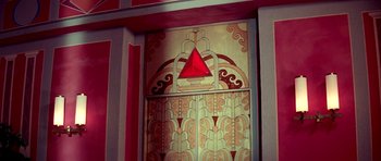 Movie still from “Suspiria” (1977), directed by Dario Argento – A door with a red triangle on the top of it; Extreme Wide shot, High angle