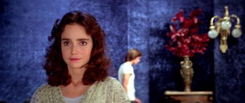 Movie still from “Suspiria” (1977), directed by Dario Argento – A woman standing in front of another woman in a room; Close Up shot, Over the shoulder angle