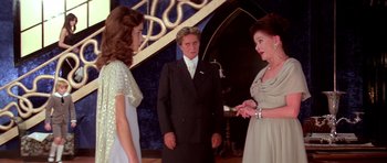 Movie still from “Suspiria” (1977), directed by Dario Argento – A group of people standing next to each other in a room; Medium shot, Over the shoulder angle