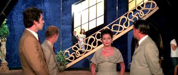 Movie still from “Suspiria” (1977), directed by Dario Argento – A woman standing in front of a stair case; Wide shot, Low angle