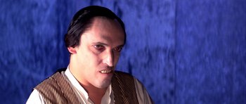 Movie still from “Suspiria” (1977), directed by Dario Argento – A person wearing a vest; Close Up shot, Over the shoulder angle
