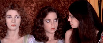 Movie still from “Suspiria” (1977), directed by Dario Argento – Two young women sitting next to each other on a couch; Close Up shot, High angle