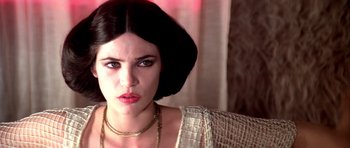 Movie still from “Suspiria” (1977), directed by Dario Argento – A person wearing a necklace; Close Up shot, Over the shoulder angle