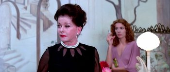 Movie still from “Suspiria” (1977), directed by Dario Argento – A woman in a black dress and a woman in a pink dress; Close Up shot, Over the shoulder angle