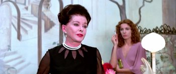 Movie still from “Suspiria” (1977), directed by Dario Argento – A woman in a black dress and a woman in a pink dress; Close Up shot, Over the shoulder angle