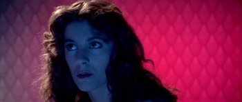 Movie still from “Suspiria” (1977), directed by Dario Argento – A person with long dark hair; Close Up shot, High angle