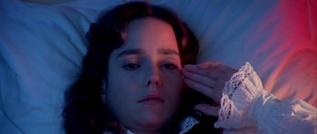 Movie still from “Suspiria” (1977), directed by Dario Argento – A woman laying in a bed with her eyes closed; Close Up shot, High angle