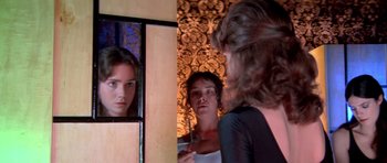 Movie still from “Suspiria” (1977), directed by Dario Argento – A woman looking in the mirror in front of a mirror; Close Up shot, Over the shoulder angle