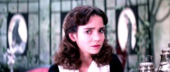 Movie still from “Suspiria” (1977), directed by Dario Argento – A person with curly brown hair; Close Up shot, Over the shoulder angle