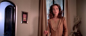 Movie still from “Suspiria” (1977), directed by Dario Argento – A woman standing in front of a window in a room; Medium shot, Over the shoulder angle
