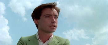 Movie still from “Suspiria” (1977), directed by Dario Argento – A person wearing a suit and tie; Close Up shot, Low angle