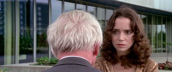 Movie still from “Suspiria” (1977), directed by Dario Argento – A man and a woman talking to each other; Close Up shot, Over the shoulder angle