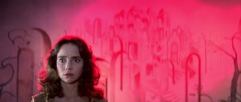 Movie still from “Suspiria” (1977), directed by Dario Argento – A woman standing in front of a pink wall; Close Up shot, Low angle