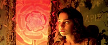 Movie still from “Suspiria” (1977), directed by Dario Argento – A young woman standing in front of a curtain; Close Up shot, High angle