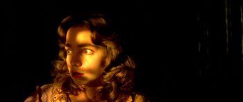 Movie still from “Suspiria” (1977), directed by Dario Argento – A woman with long brown curly hair stares at the camera; Close Up shot, Low angle