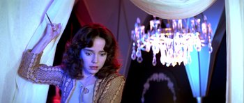 Movie still from “Suspiria” (1977), directed by Dario Argento – A young woman in front of chandeliers in a room; Medium shot, Low angle