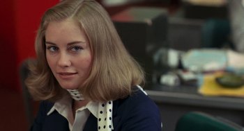 Movie still from “Taxi Driver” (1976), directed by Martin Scorsese – A woman with blonde hair wearing a polka dot neck tie; Close Up shot, Over the shoulder angle