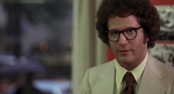 Movie still from “Taxi Driver” (1976), directed by Martin Scorsese – A man in a white suit and a red tie; Close Up shot, Low angle