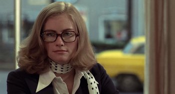 Movie still from “Taxi Driver” (1976), directed by Martin Scorsese – A woman wearing glasses and a neck scarf; Close Up shot, Low angle