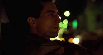 Movie still from “Taxi Driver” (1976), directed by Martin Scorsese – A person looking up at lights; Close Up shot, Low angle