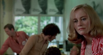 Movie still from “Taxi Driver” (1976), directed by Martin Scorsese – A woman with long blonde hair is looking at the camera; Close Up shot, Over the shoulder angle