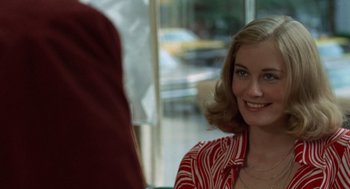 Movie still from “Taxi Driver” (1976), directed by Martin Scorsese – A woman in a red and white striped shirt smiling; Close Up shot, Over the shoulder angle