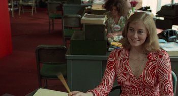 Movie still from “Taxi Driver” (1976), directed by Martin Scorsese – A woman sitting at a table in a room; Medium shot, Over the shoulder angle