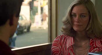 Movie still from “Taxi Driver” (1976), directed by Martin Scorsese – A woman sitting in front of a store window; Close Up shot, Over the shoulder angle