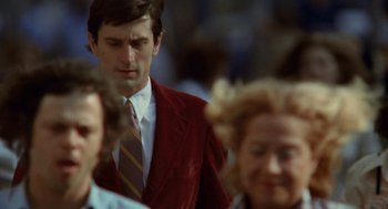 Movie still from “Taxi Driver” (1976), directed by Martin Scorsese – A man in a red jacket and a woman in a red jacket; Medium shot, Over the shoulder angle