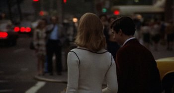 Movie still from “Taxi Driver” (1976), directed by Martin Scorsese – A man and a woman walking down a street; Medium shot, Over the shoulder angle