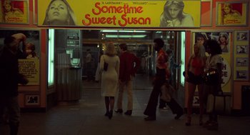 Movie still from “Taxi Driver” (1976), directed by Martin Scorsese – People walking on a sidewalk in front of a movie theater; Extreme Wide shot, Low angle