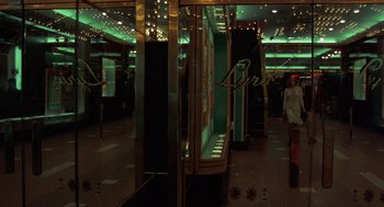 Movie still from “Taxi Driver” (1976), directed by Martin Scorsese – A woman standing in front of a store window; Wide shot, Low angle