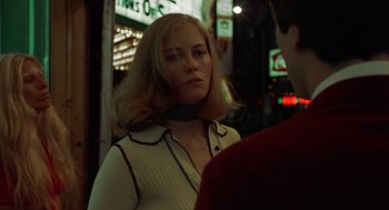 Movie still from “Taxi Driver” (1976), directed by Martin Scorsese – A woman with blonde ringlets standing next to a man; Close Up shot, Low angle