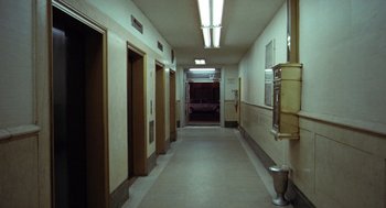 Movie still from “Taxi Driver” (1976), directed by Martin Scorsese – A hallway with a toilet and two urinals in it; Extreme Wide shot, High angle