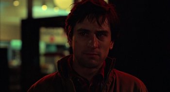 Movie still from “Taxi Driver” (1976), directed by Martin Scorsese – A person wearing a jacket; Close Up shot, Over the shoulder angle