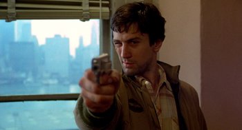 Movie still from “Taxi Driver” (1976), directed by Martin Scorsese – A man holding a cell phone in his hand; Close Up shot, Low angle