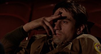 Movie still from “Taxi Driver” (1976), directed by Martin Scorsese – A person with a hand on his face; Close Up shot, Low angle