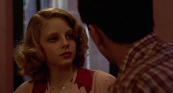 Movie still from “Taxi Driver” (1976), directed by Martin Scorsese – A young girl looking at a young man in a mirror; Close Up shot, Over the shoulder angle