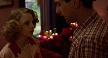 Movie still from “Taxi Driver” (1976), directed by Martin Scorsese – A man and a woman standing next to each other in front of candles; Close Up shot, Over the shoulder angle