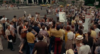 Movie still from “Taxi Driver” (1976), directed by Martin Scorsese – A large group of people gathered on the side of the street; Extreme Wide shot, High angle