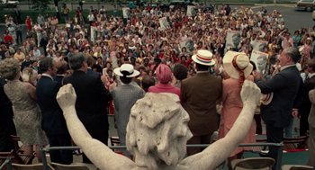 Movie still from “Taxi Driver” (1976), directed by Martin Scorsese – A crowd of people are gathered around a statue; Extreme Wide shot, High angle